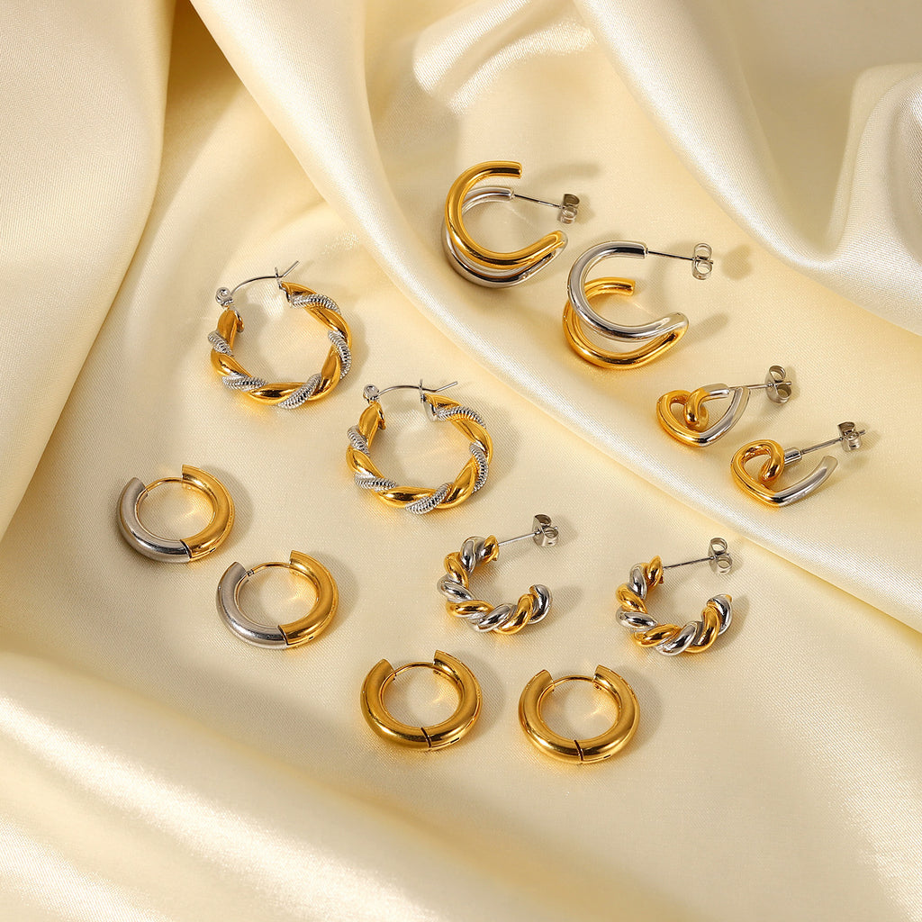 Mixed gold-and-silver-tone earring styles displayed on fabric