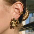 Gold-Tone Floral Stainless Steel Earring Collection shown on model