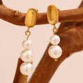 gold plated asymmetrical two- and three-pearl drop earrings