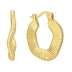 gold plated irregular ribbed hoop earrings isolated on white