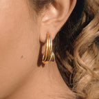 sculptural spiral stainless steel hoop earring worn in profile
