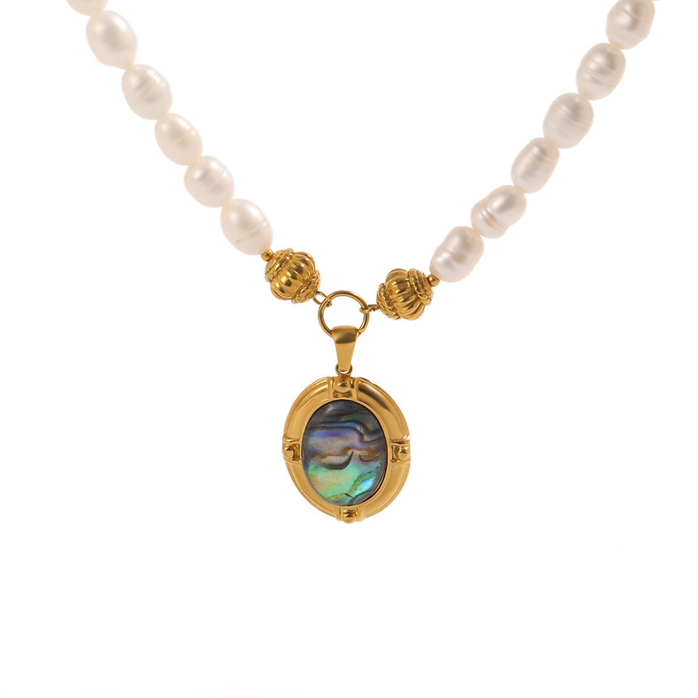 Oval iridescent pendant and textured bead details on white