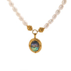 Oval iridescent pendant and textured bead details on white
