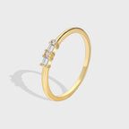 isolated gold plated brass band ring with baguette and round clear stones
