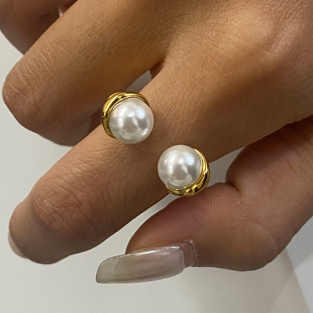 Gold plated double pearl-look open ring worn on a hand
