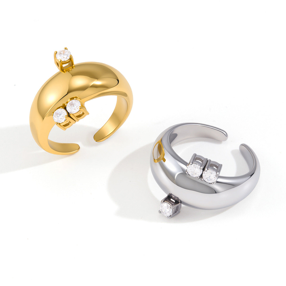 Gold and silver tone open rings showing polished curved bands
