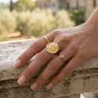 Classical portrait ring worn beside separate slim bands