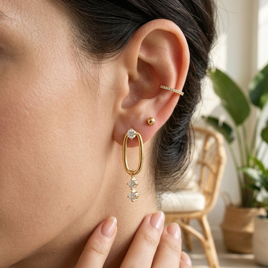 Oval link stone drop earrings worn with additional ear jewelry