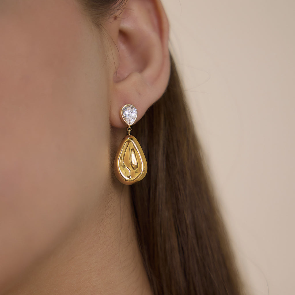 Two-part teardrop earring worn on an ear