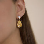 Two-part teardrop earring worn on an ear