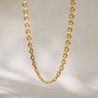 Full gold-tone patterned chain hanging vertically