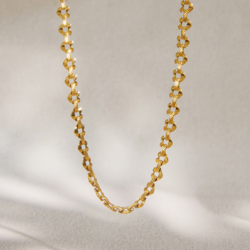Full gold-tone patterned chain hanging vertically