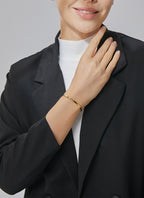 model wearing a slim minimalist gold plated brass bangle