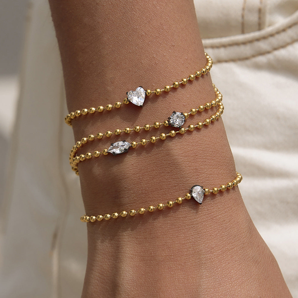 Dark-set zirconia centers on gold-tone chains