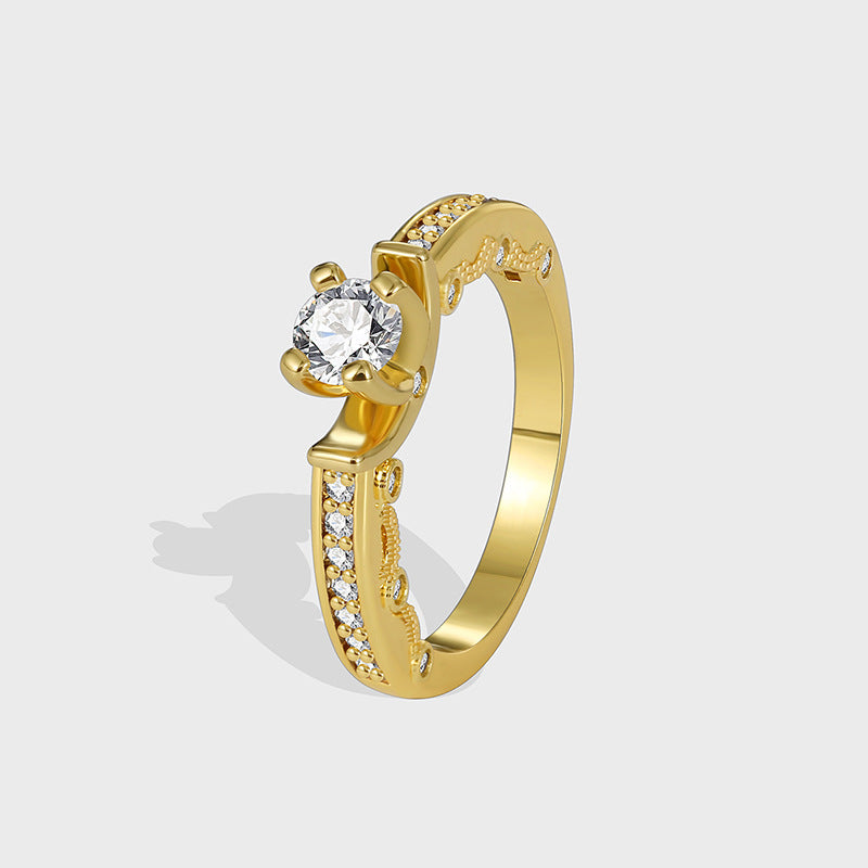 gold plated brass solitaire ring with a round clear center stone