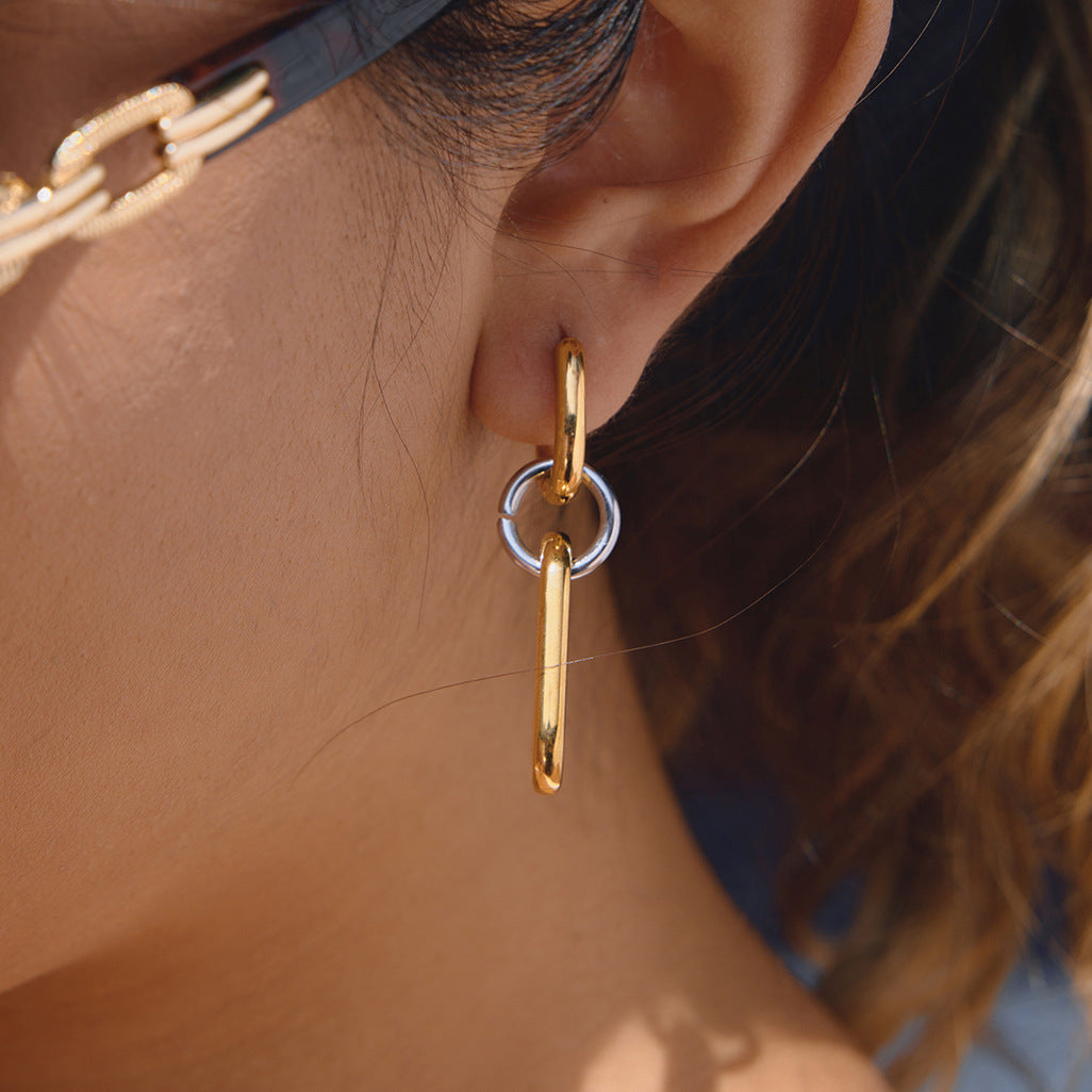 gold plated and silver-finish elongated linked earring worn on ear