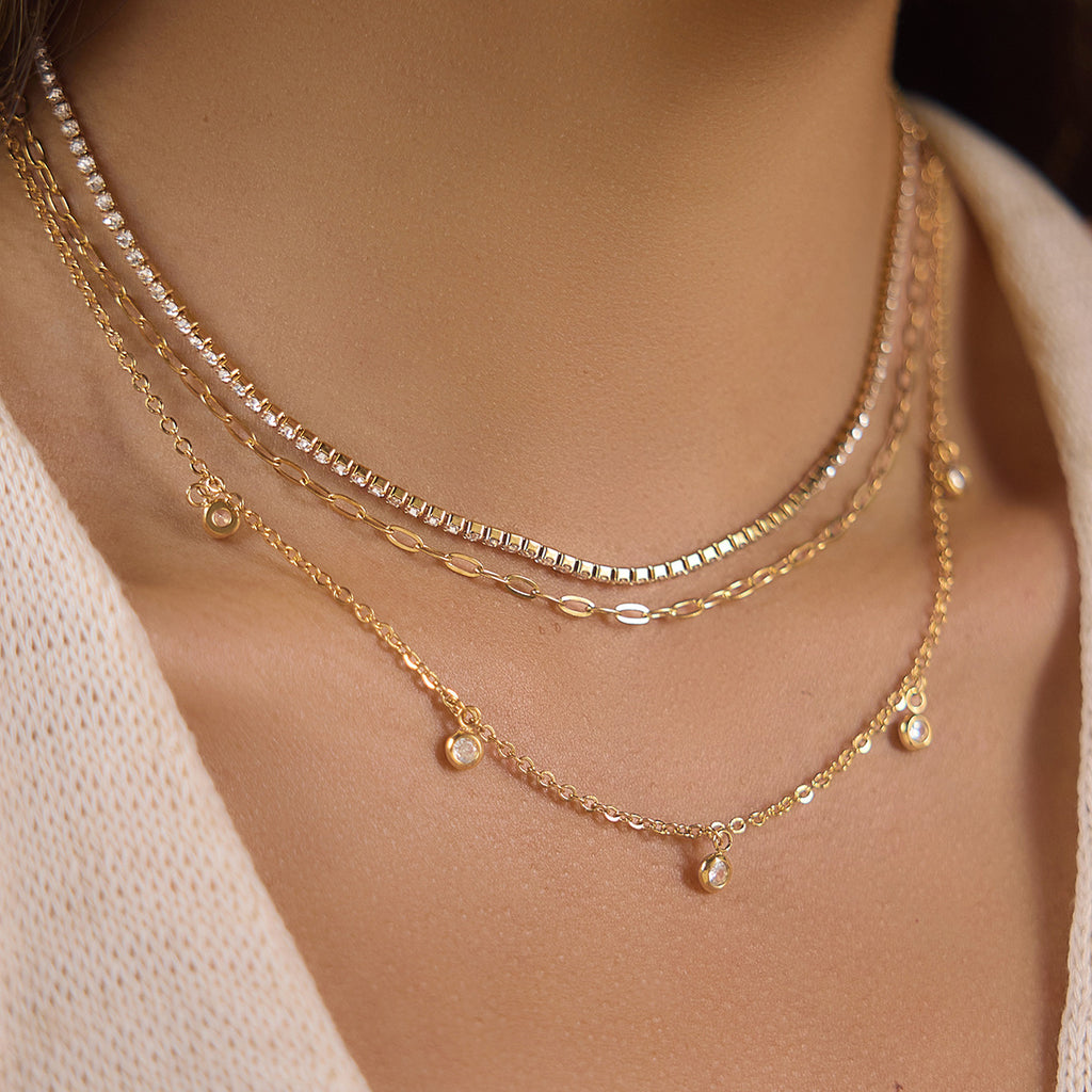 Clear stone line oval links and charm chain worn together