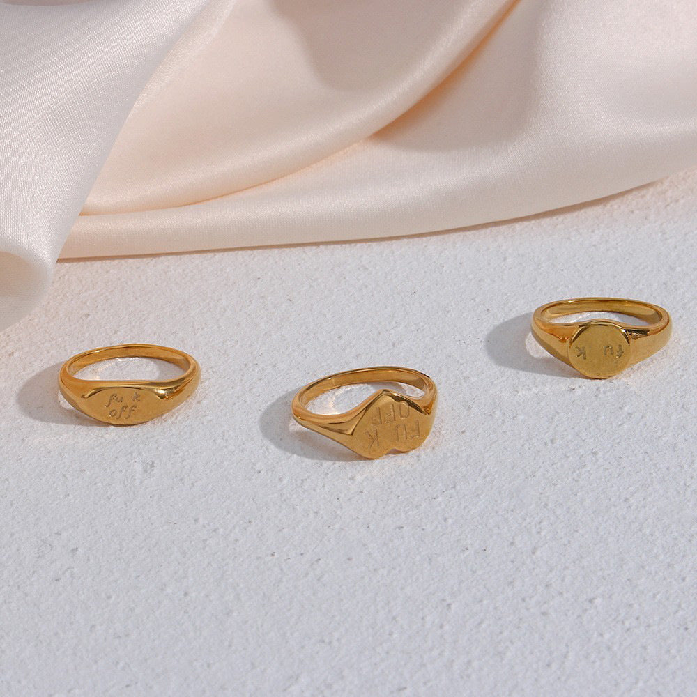 Engraved signet ring selection on a light surface
