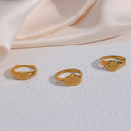 Engraved signet ring selection on a light surface