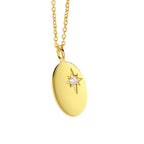 angled view of polished oval pendant and central clear stone