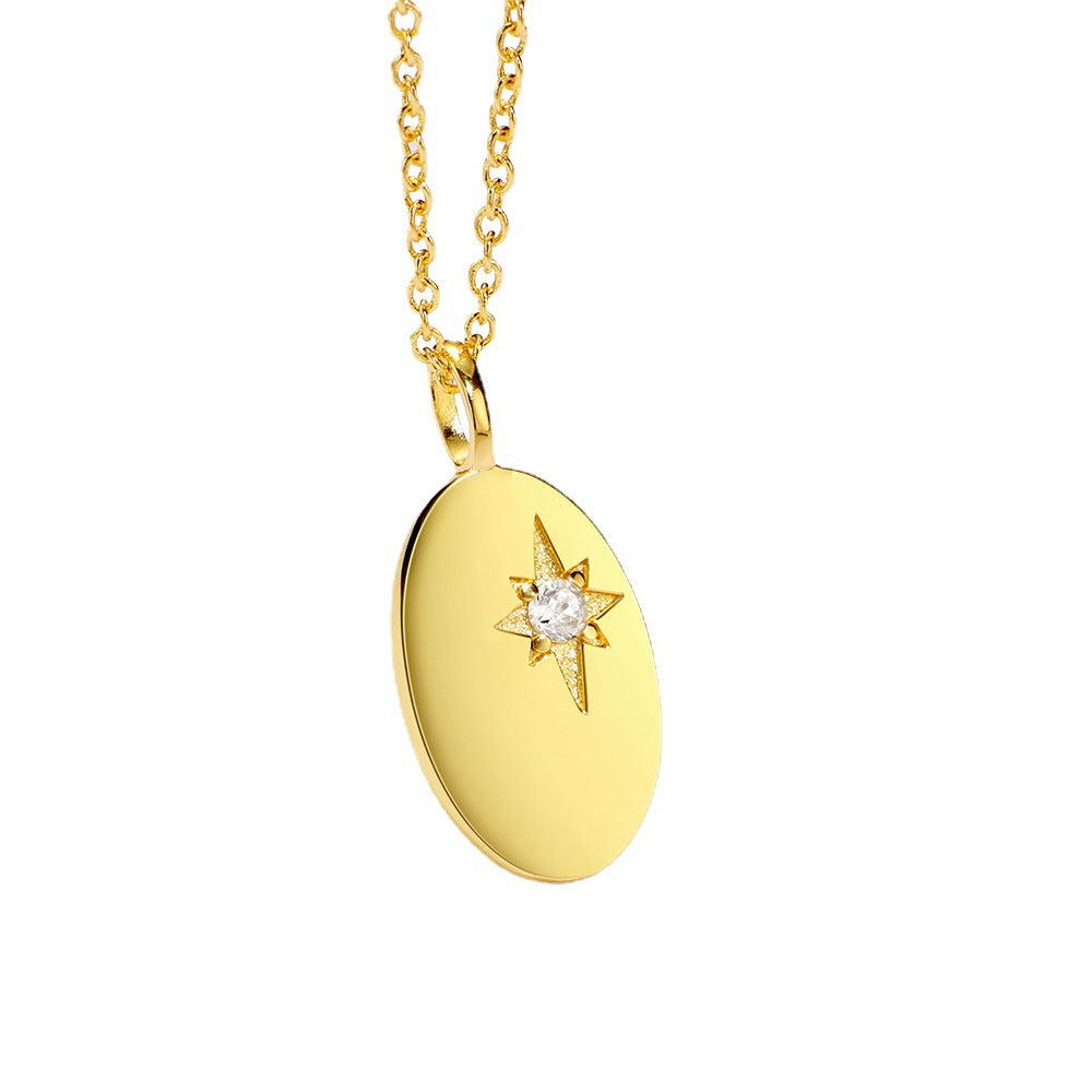 angled view of polished oval pendant and central clear stone