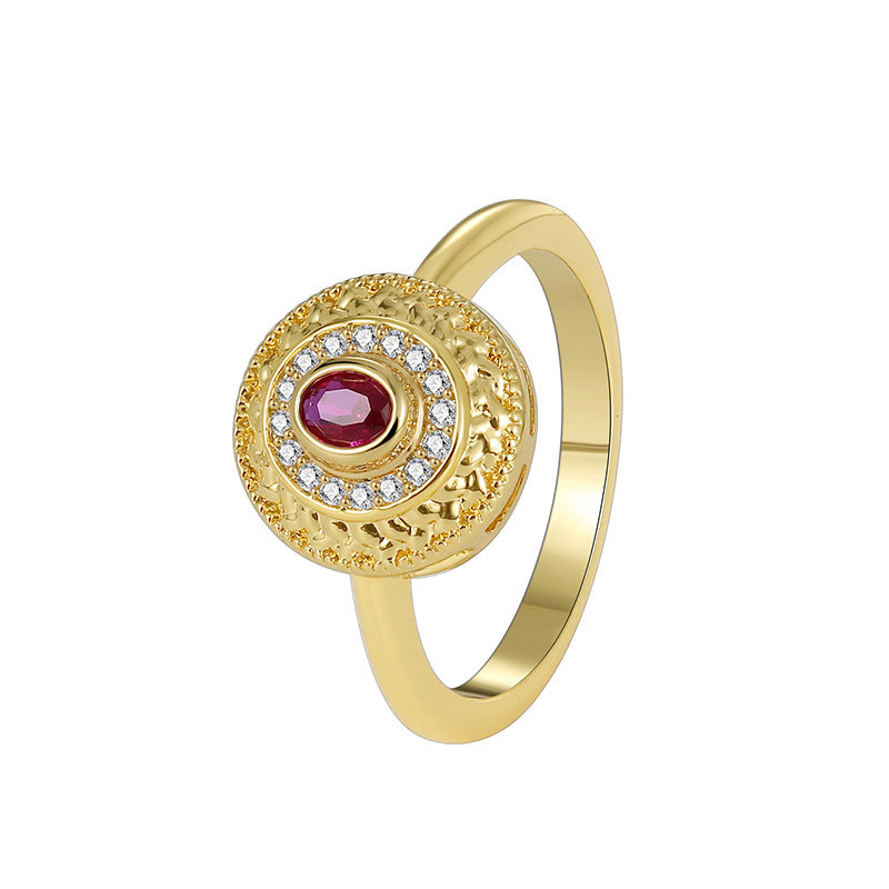 cutout of vintage-style red and clear stone medallion ring