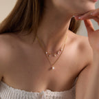 Pearl-look drop necklace with smaller white and clear accents