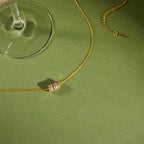 Multicolor cube station necklace arranged beside a glass