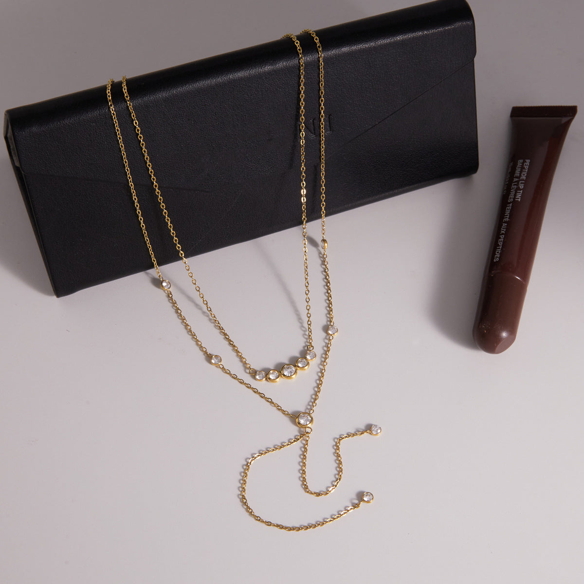 Layered necklace arranged on a black display