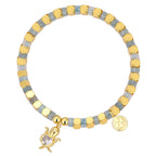 isolated gold plated turtle charm bracelet with blue-gray beads