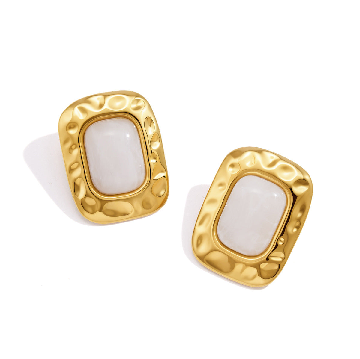 Pair of white resin studs with rounded gold tone borders