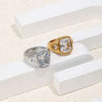 two-finish stainless steel signet rings on a geometric display
