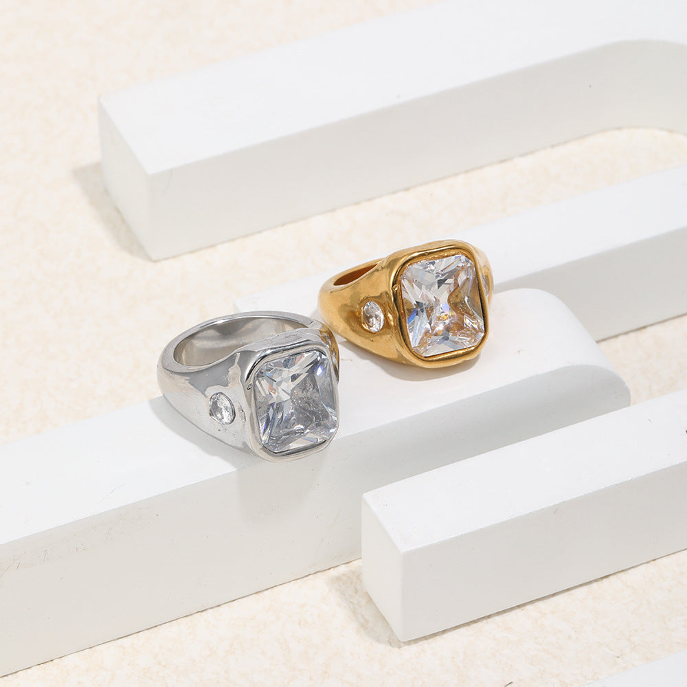 two-finish stainless steel signet rings on a geometric display