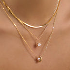 Three-layer moon and star necklace close-up at neckline