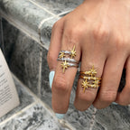 Celestial open rings with gold tone stars shown on two hands