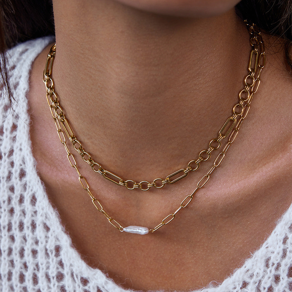 Model wearing gold-tone stainless steel paperclip necklace with elongated white bead