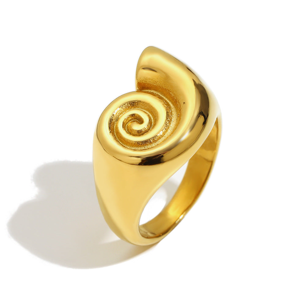 Sculpted gold tone spiral ring on white