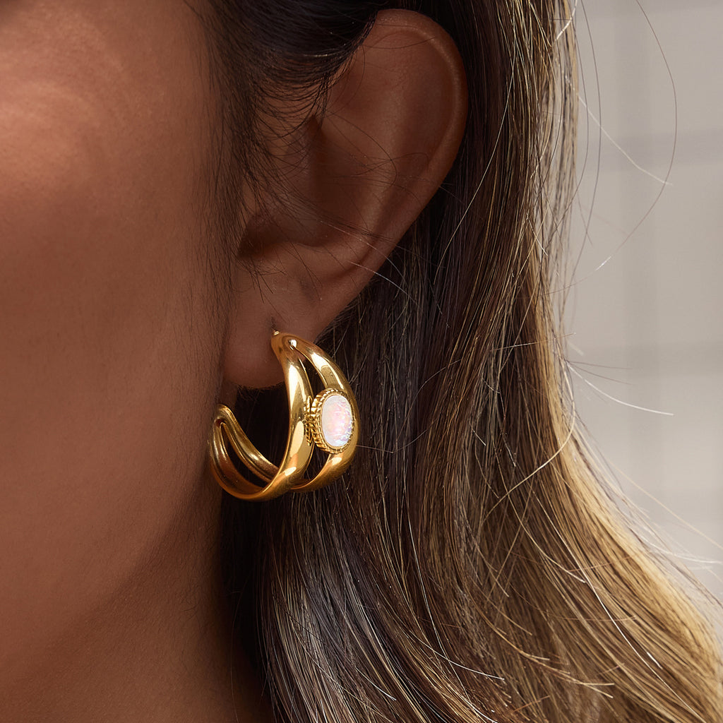 Double curved band earring worn on an ear