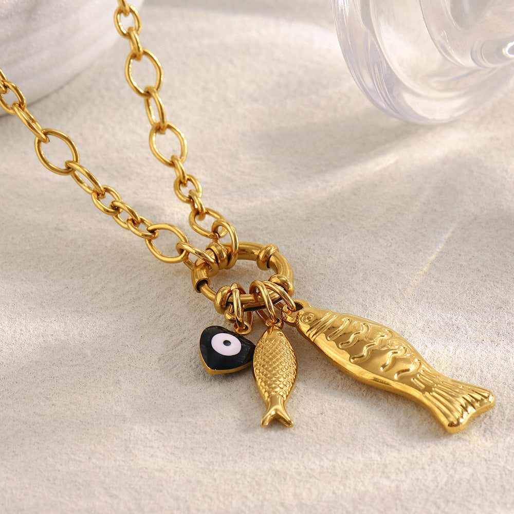close view of textured fish charms and black-and-white round accent