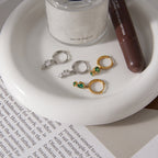 Two huggie color options displayed on a tray