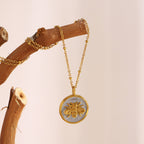 two-tone stainless steel bee medallion necklace held by the chain