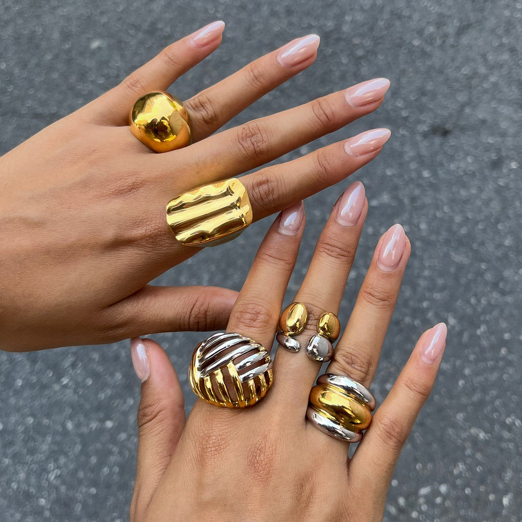 Dome ridged and openwork rings shown on fingers
