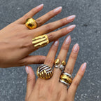 Dome ridged and openwork rings shown on fingers