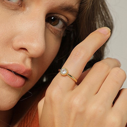 close worn view of slim gold plated bezel solitaire ring