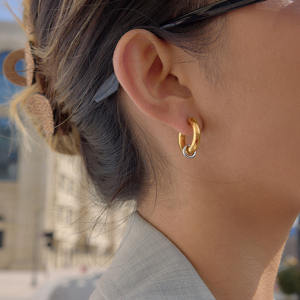 two-tone ring-accent C-hoop earring worn on ear