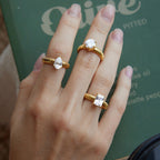 Three ribbed stainless steel rings shown on a hand