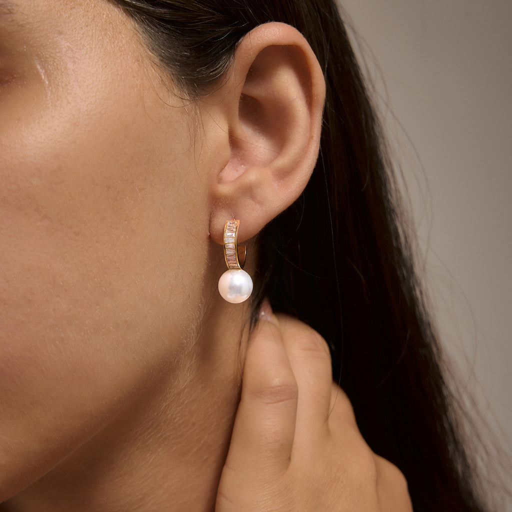 White glass pearl drop and zirconia hoop shown on an ear