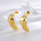 gold plated brass folded petal stud earrings in studio