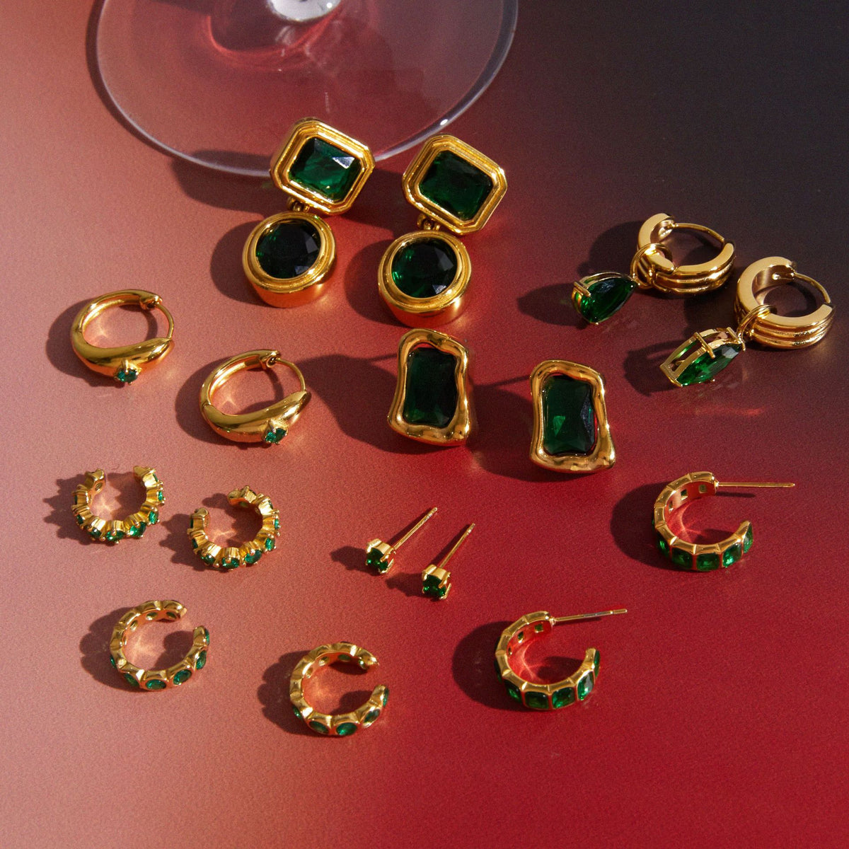 Mix of green accent hoops, studs and drop earrings
