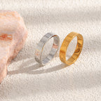 Two marine-patterned ring finishes shown upright